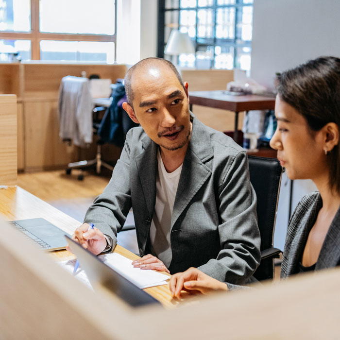A man and woman talking in an office